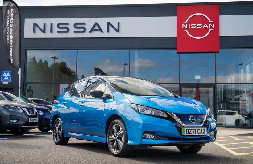 Nissan Leaf in front of dealer, blue, UK plates, 71 registration
